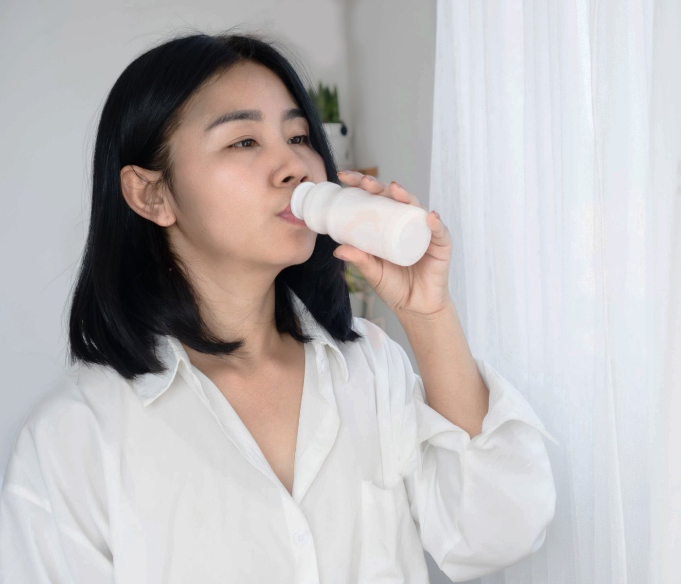 woman drinking fermented milk yogurt