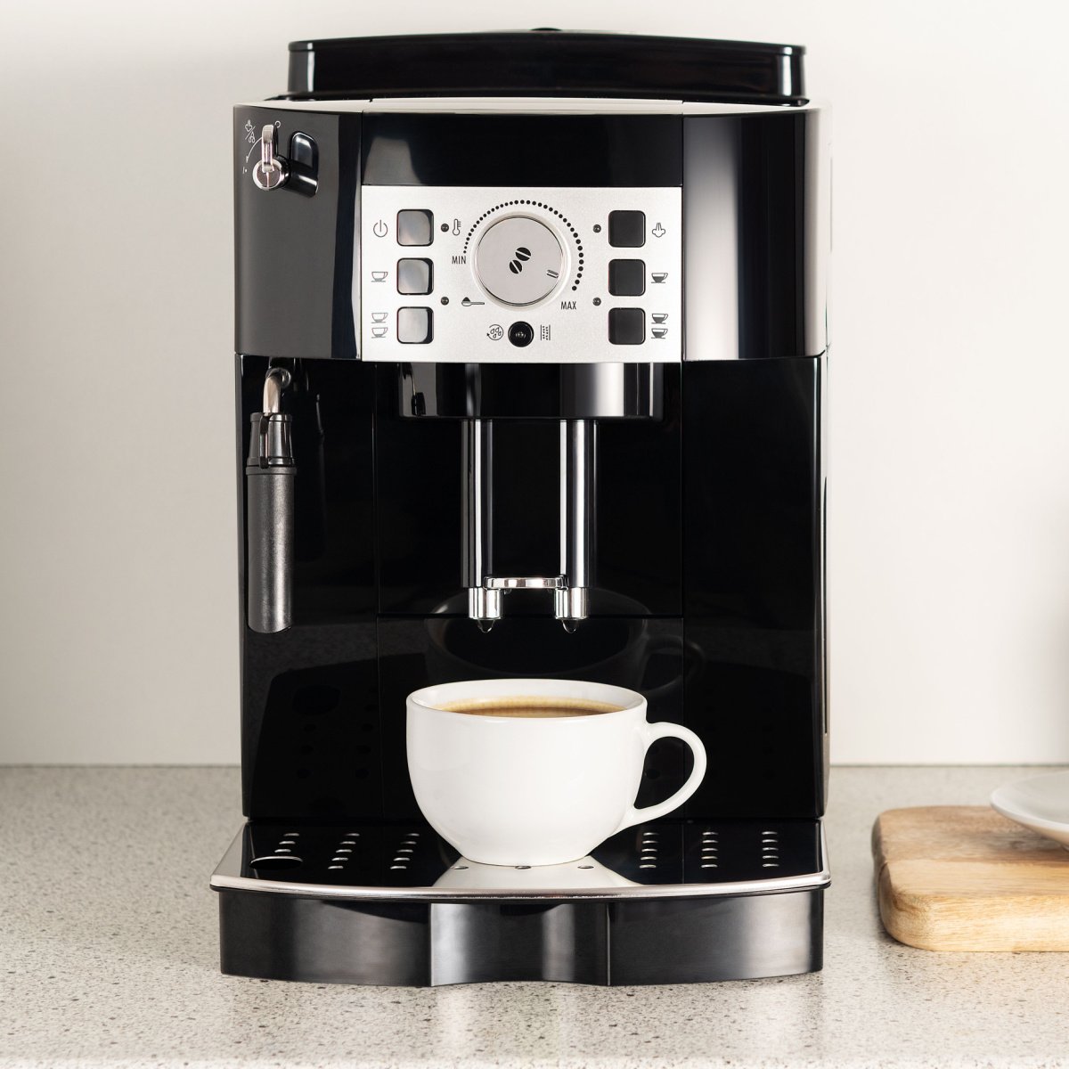 https://tastylicious.com/wp-content/uploads/2022/12/black-modern-coffee-maker-on-countertop-beside-wall-with-freshly-brewed-cup-of-coffee.jpg