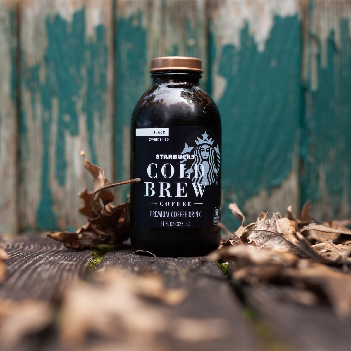 bottled starbucks cold brew on ground surrounded by fallen leaves
