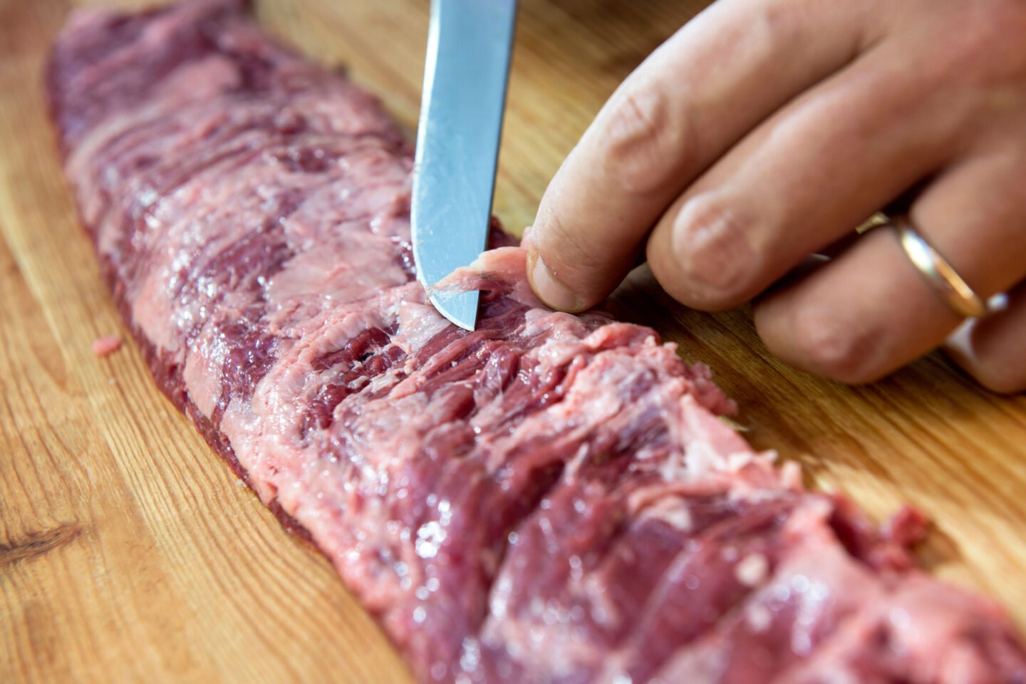 butcher finishes raw skirt steak