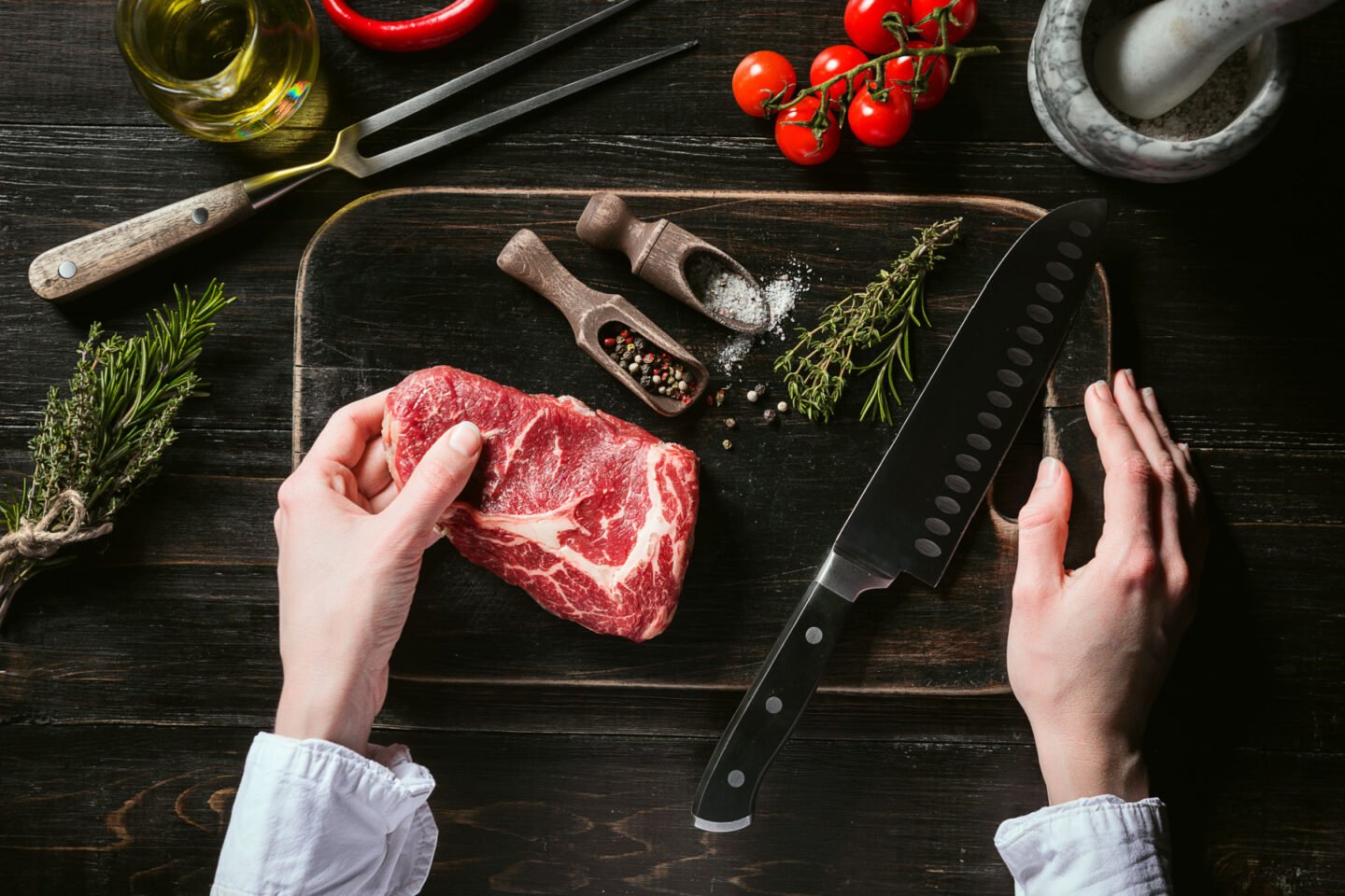 chef prepares rib eye steak