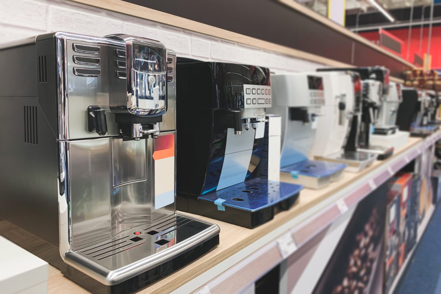 https://tastylicious.com/wp-content/uploads/2022/12/coffee-makers-lined-up-on-display-in-appliance-shelf-store.jpg