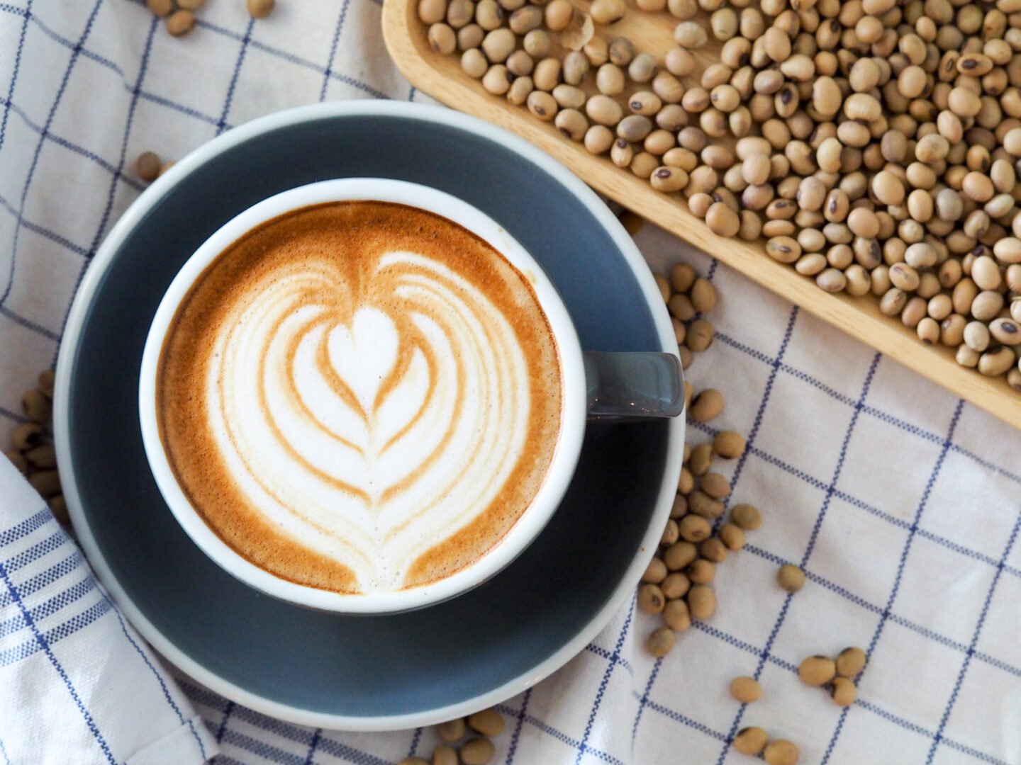 Soy,Latte,With,Soybean,Background,On,Wood,Board,And,White