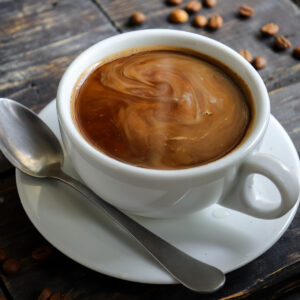 freshly made americano in white ceramic mug on wooden table