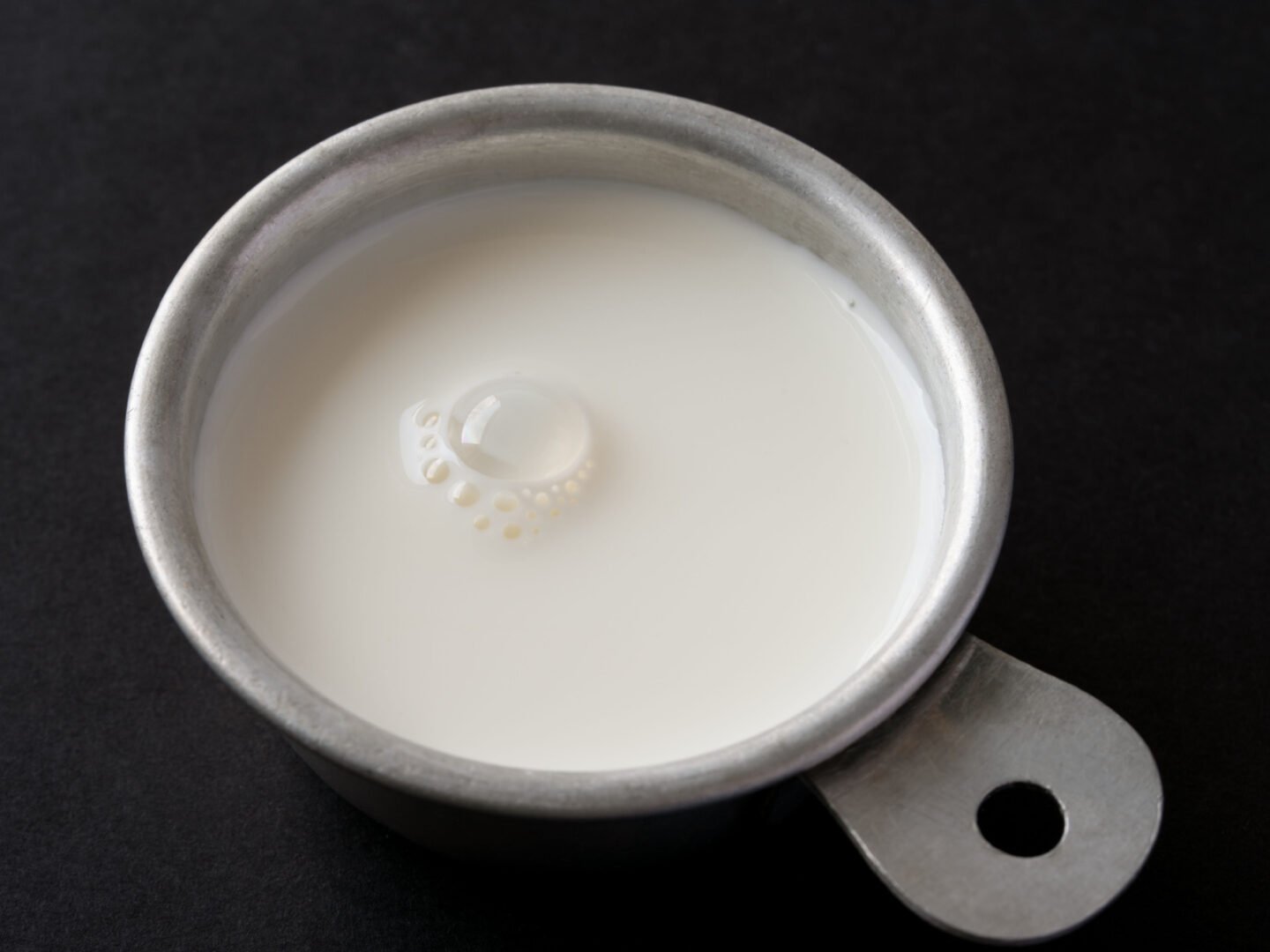 half and half cream in a measuring cup