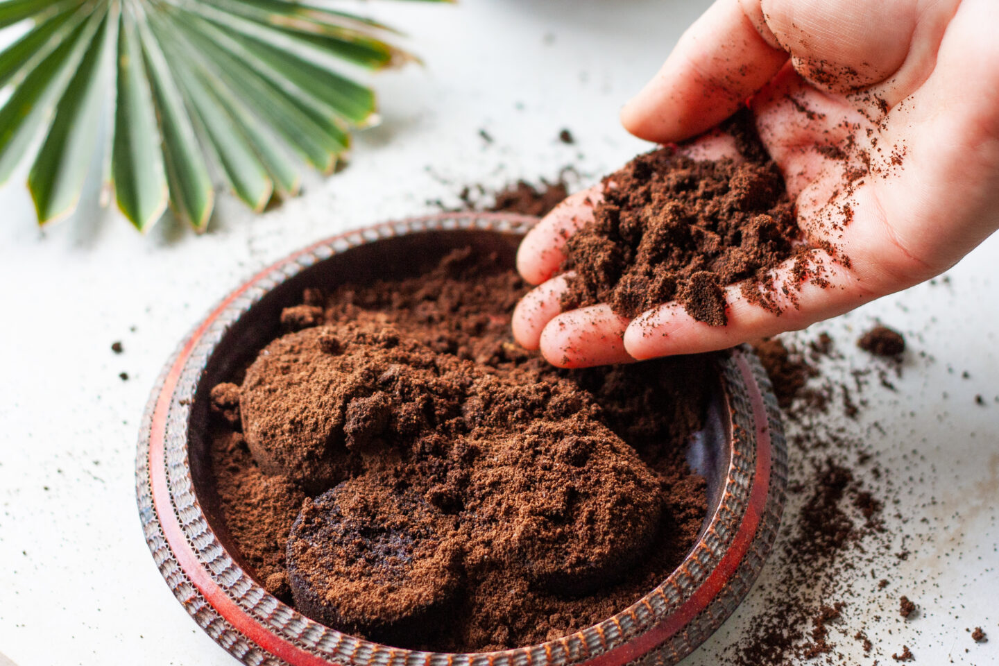 Woman's,Hand,Crumbles,Coffee,Grounds,Into,Wooden,Bowl.,Coffee,Grounds