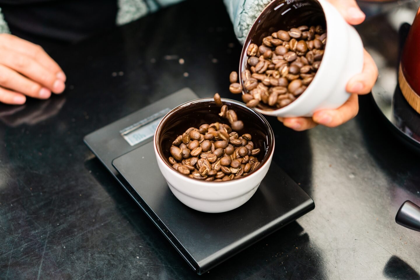 Hand,Of,An,Unrecognizable,Employee,Weighing,Coffee,Beans.