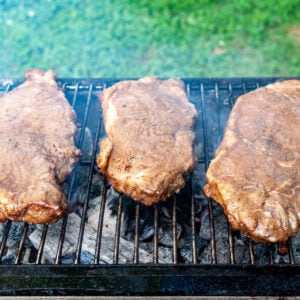 marinated flat iron steaks on an outdoor grill