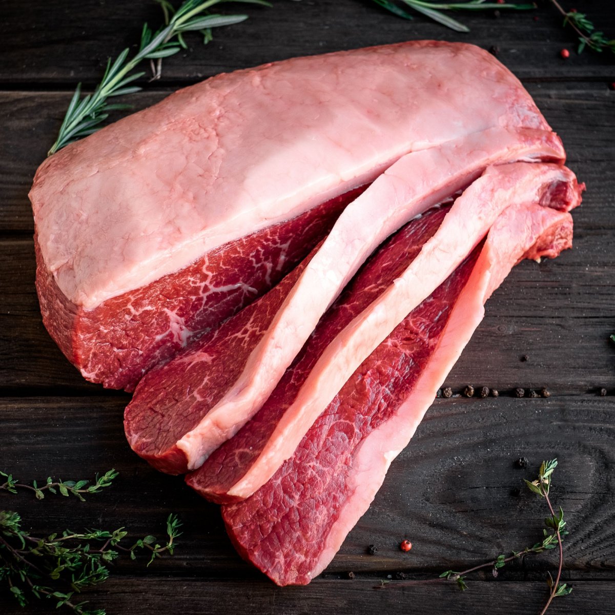 raw brisket beef cut on a wooden table