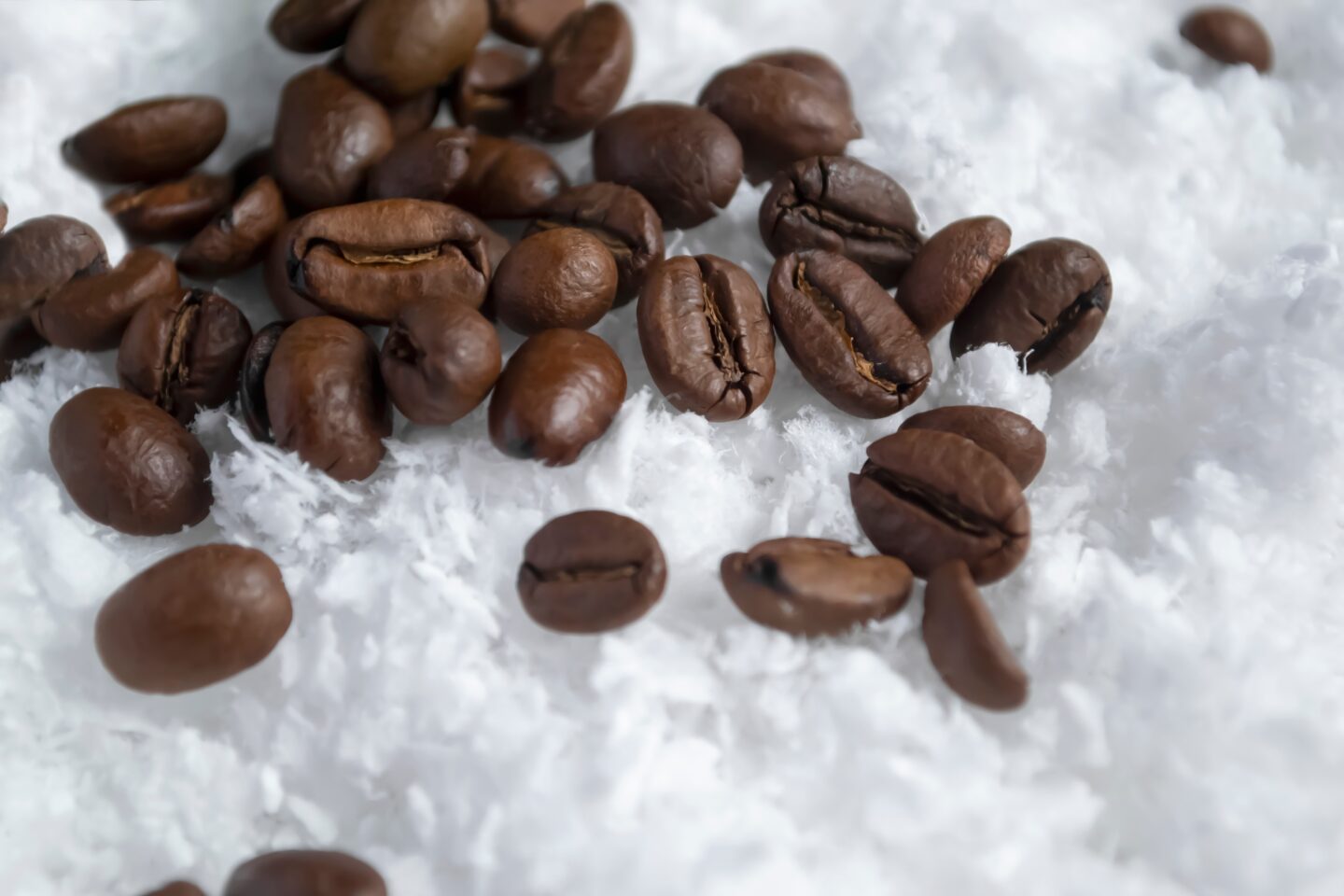 Coffee,Beans,In,The,Snow.,Coffee,Beans,Are,Scattered,On