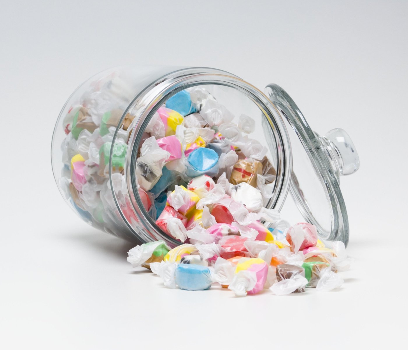 saltwater taffy spilling out of glass jar