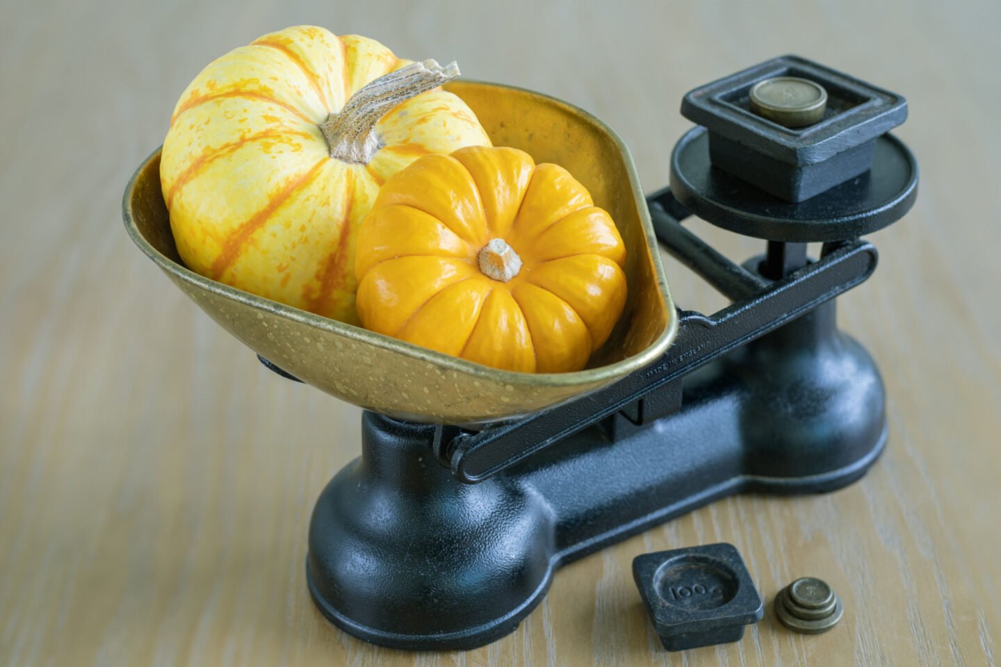 small pumpkins on a vintage weighing scale