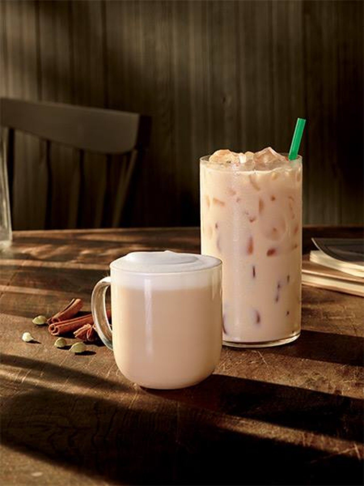 starbucks hot and iced chai tea latte in glasses on wooden table