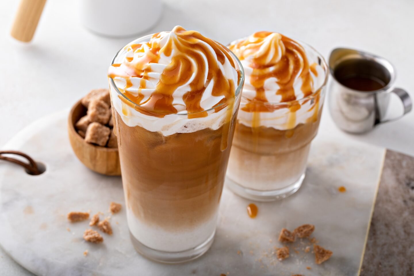 Iced,Caramel,Latte,Topped,With,Whipped,Cream,And,Caramel,Sauce,