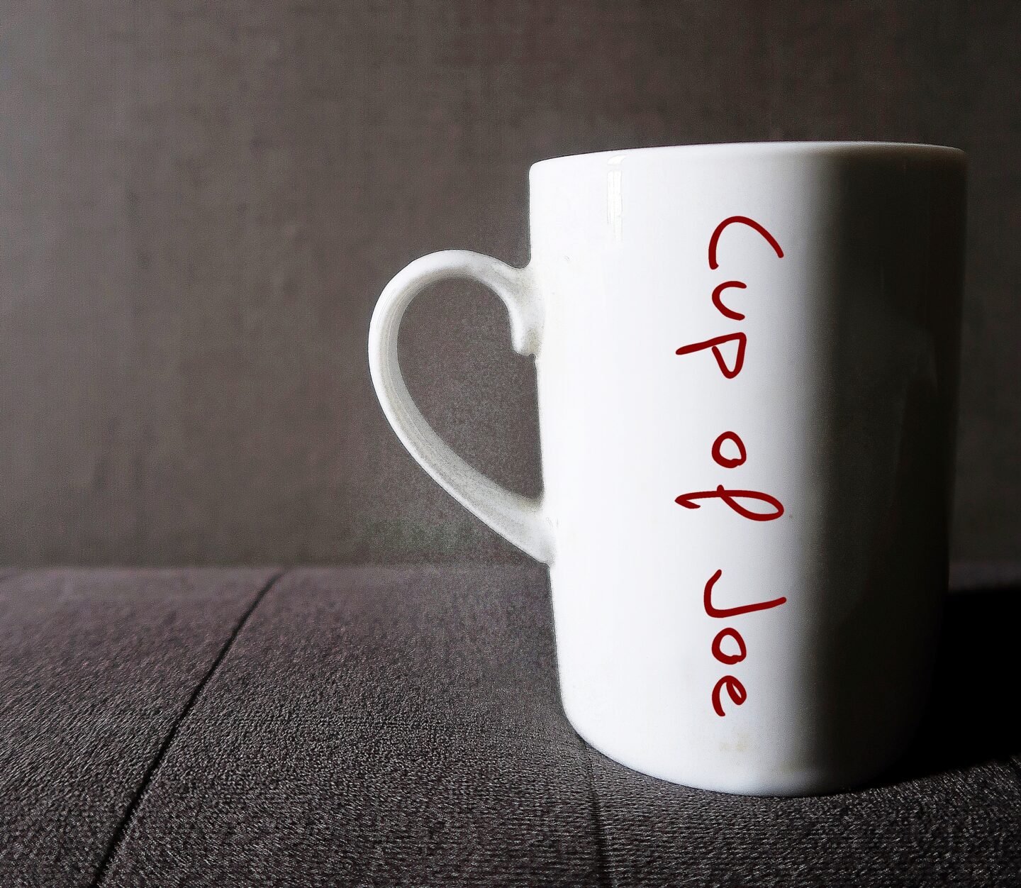 White,Mug,On,Sofa,With,Text,On,The,Side,Cup