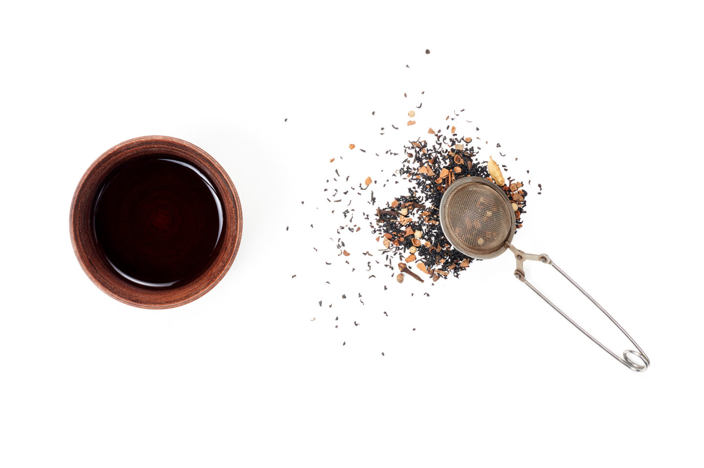a-cup-of-chai-concentrate-beside-strainer
