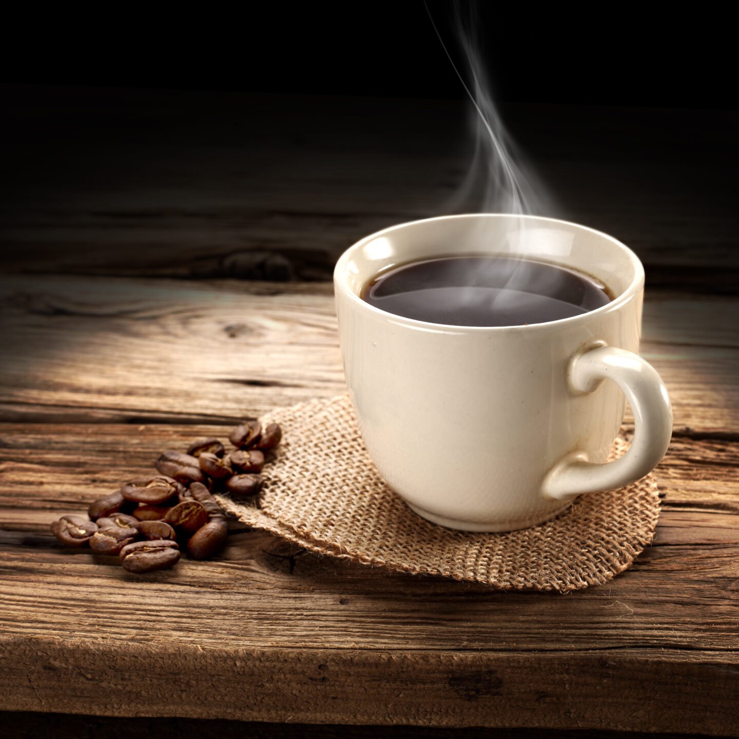 a-cup-of-steaming-hot-coffee-on-a-wooden-table