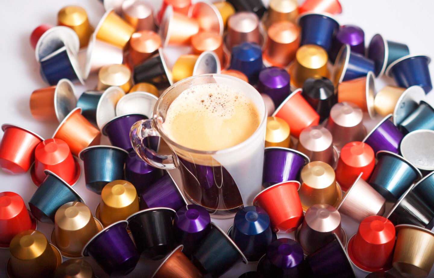 a-pile-of-nespresso-pods-with-a-cup-of-coffee-in-the-middle