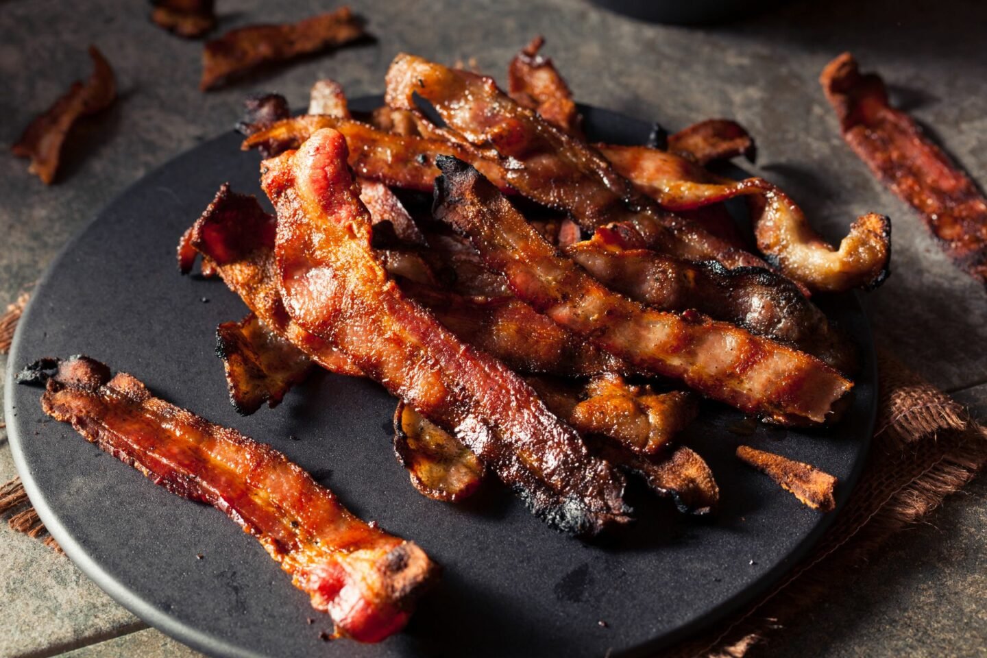 bacon rashers on black plate