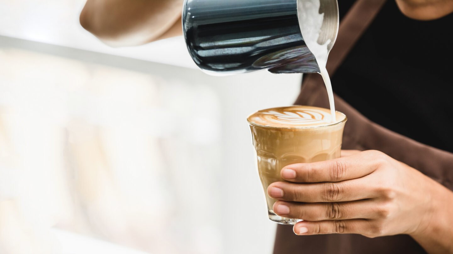 Professional,Barista,Pouring,Steamed,Milk,Into,Coffee,Glass,Cup,Making