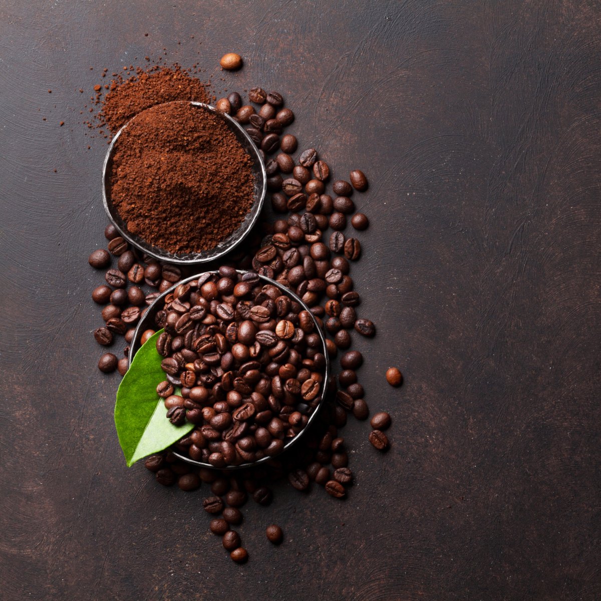 coffee-beans-and-ground-powder-on-stone-background