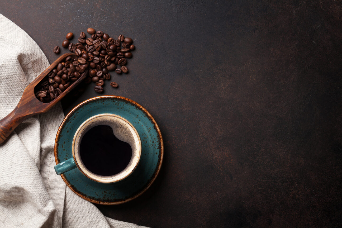 coffee-cup-and-beans-on-old-kitchen-table