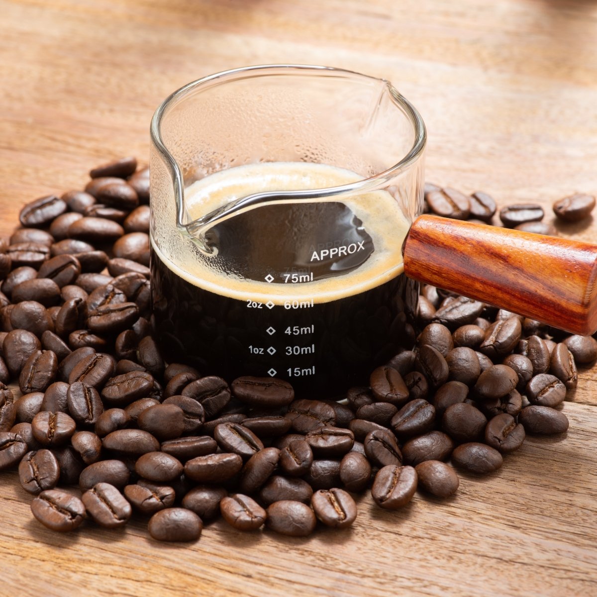 espresso coffee in a wooden handle measuring cup