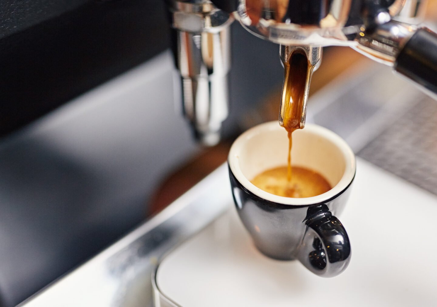 espresso-machine-pouring-fresh-espresso-coffee-into-a-neat-ceramic-cup