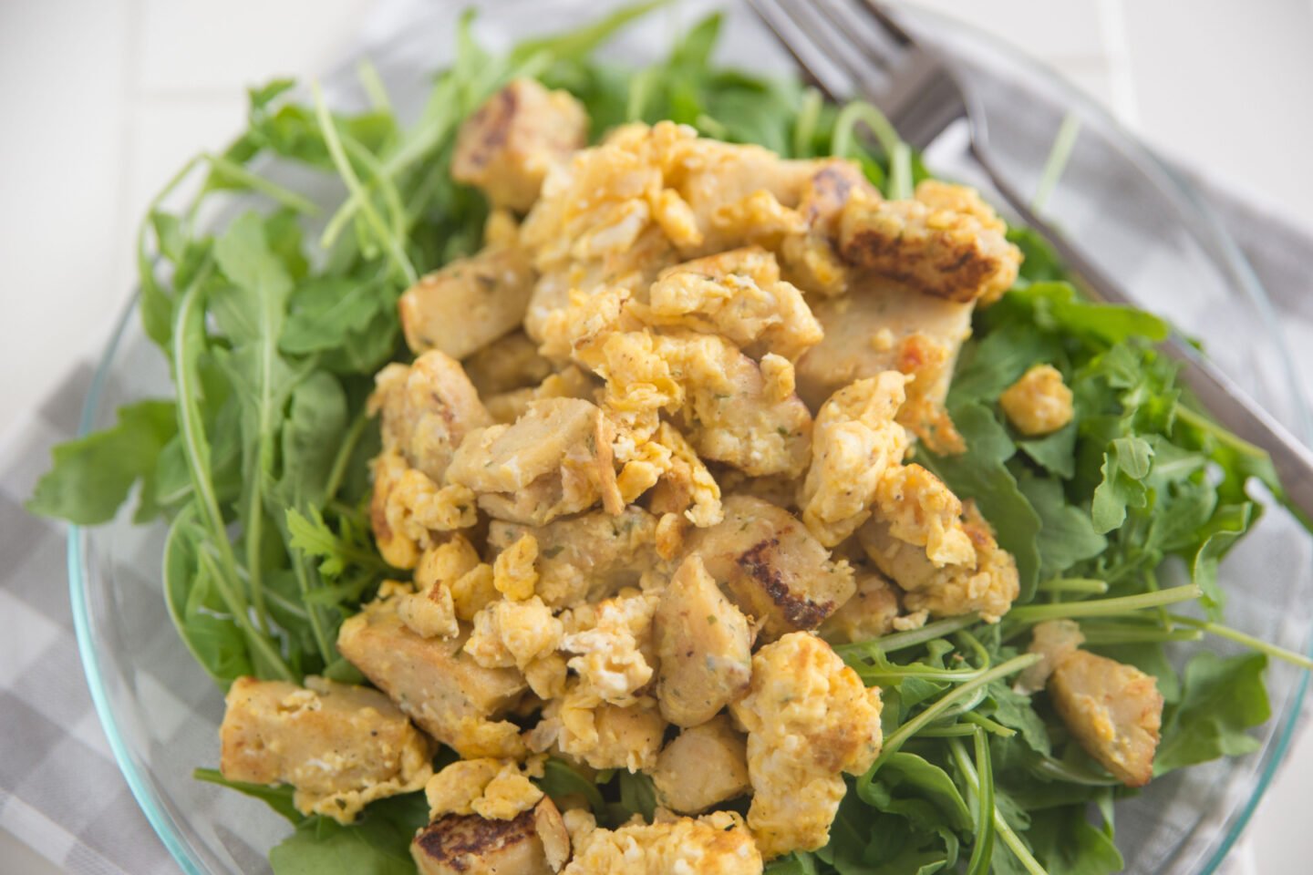 fried dumplings with scrambled egg served on fresh greens