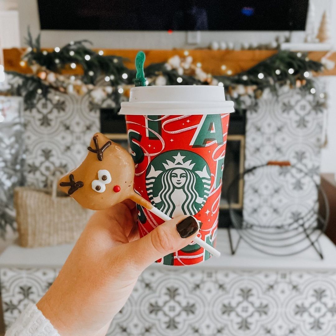 hand holding reindeer cake pops with red starbucks holiday cup