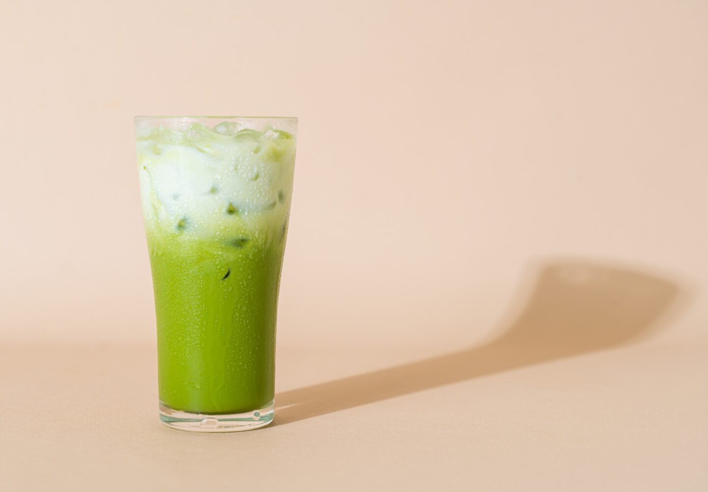 Iced,Matcha,Green,Tea,Latte,With,Milk,Layer,In,Glass