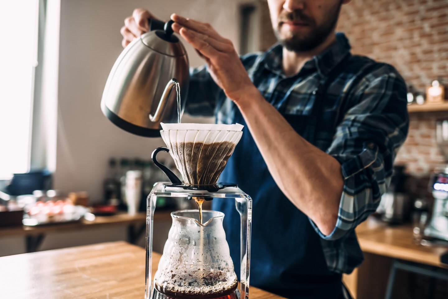 man-prepares-coffee-in-pour-over-style