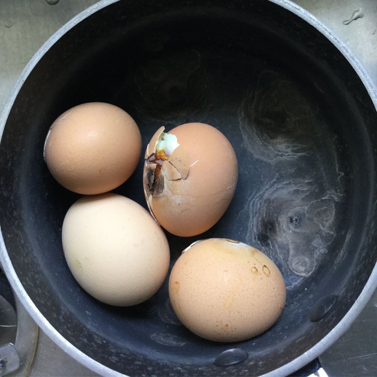 overcooked brown eggs in a pot