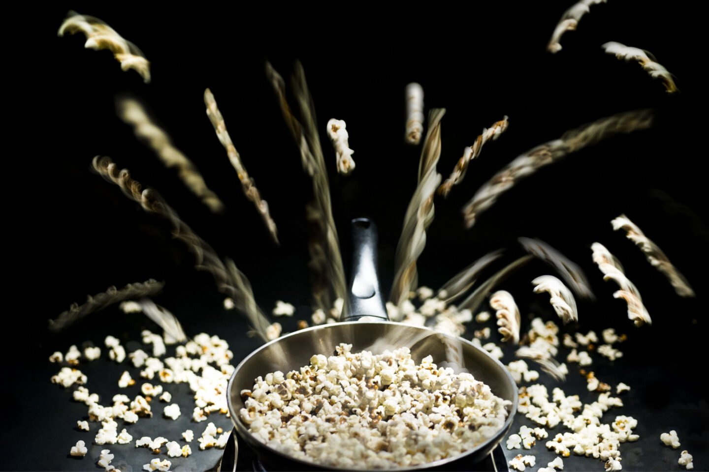 popcorn popping out from a pot