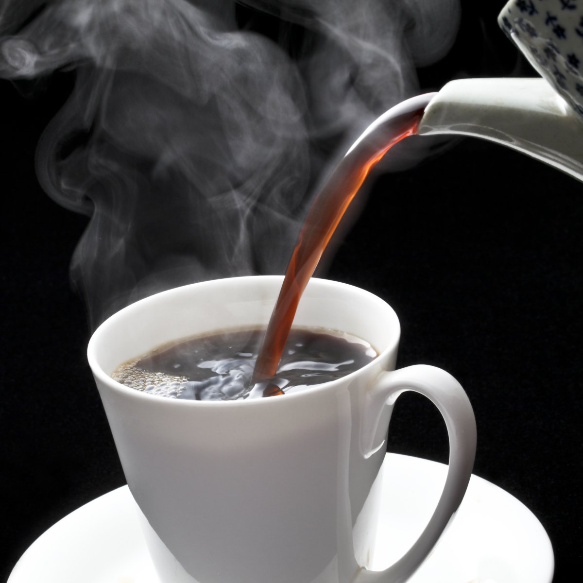 pouring-hot-coffee-on-a-white-cup-from-a-kettle