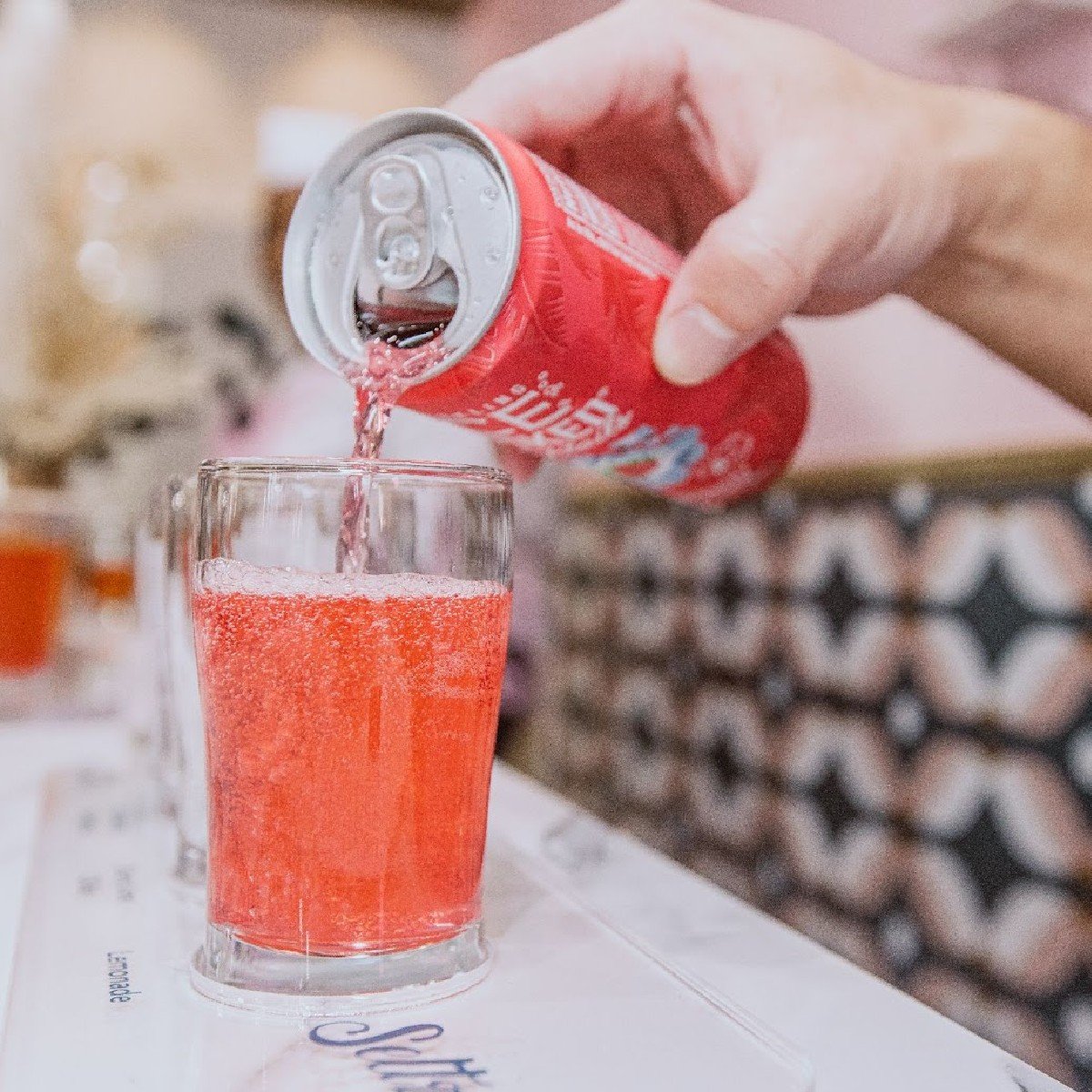 pouring sparkling flavored water into glass