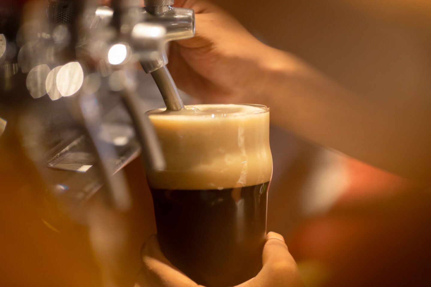 pouring stout beer from tap