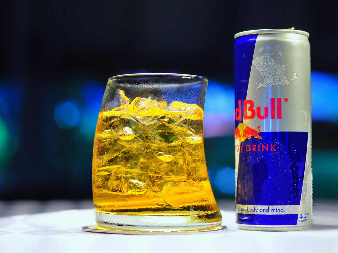 red bull in glass and can