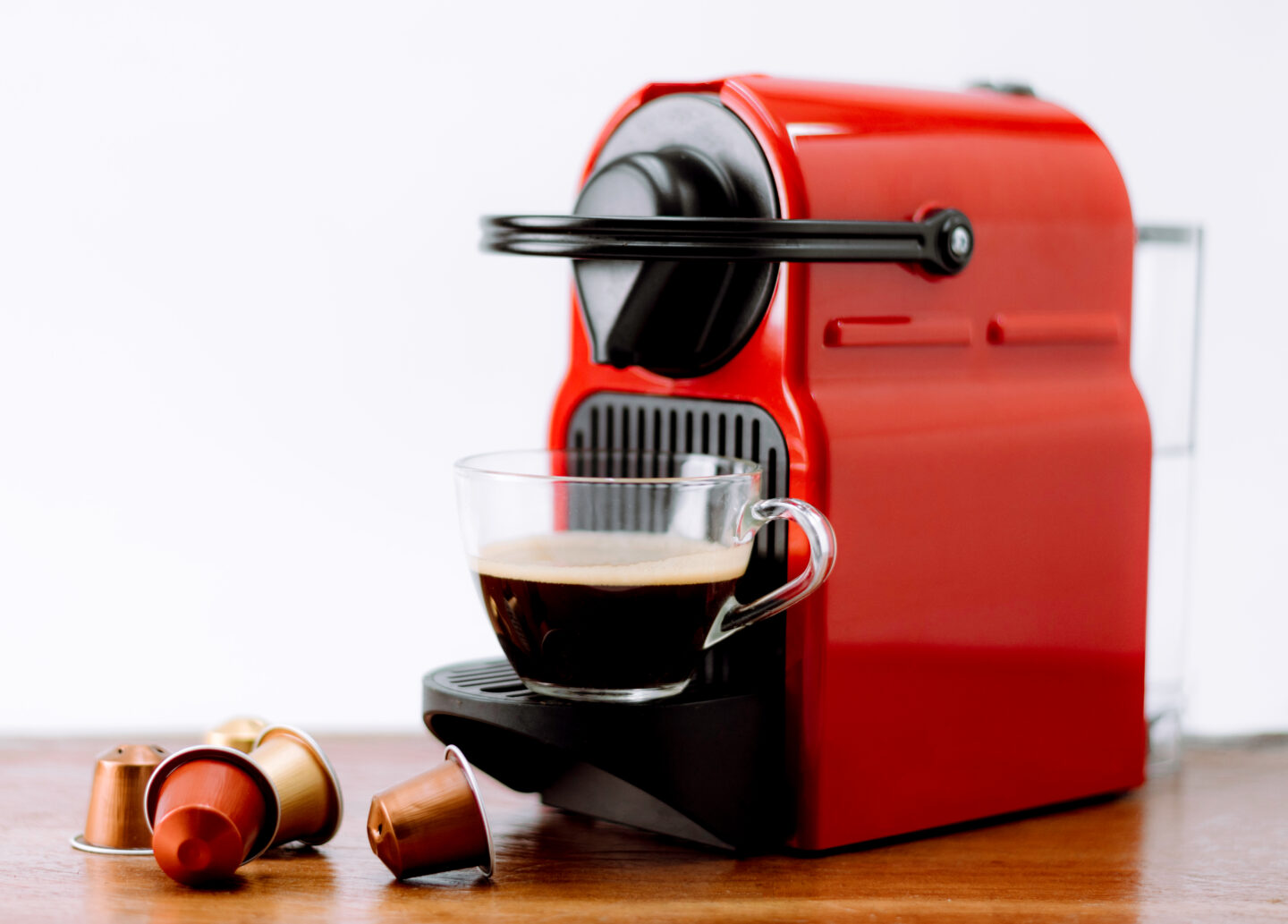 red-nespresso-machine-with-coffee-cup