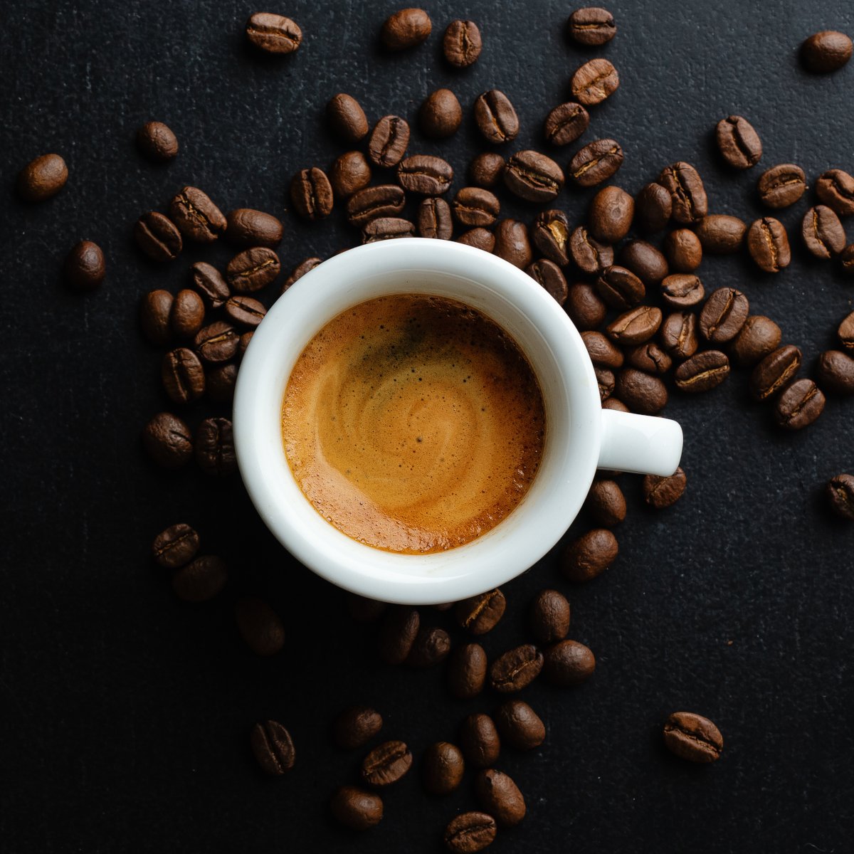 steaming-espresso-in-cup-with-coffee-beans