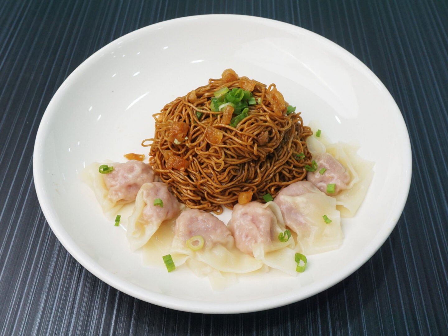 stir fried noodles served with dumplings