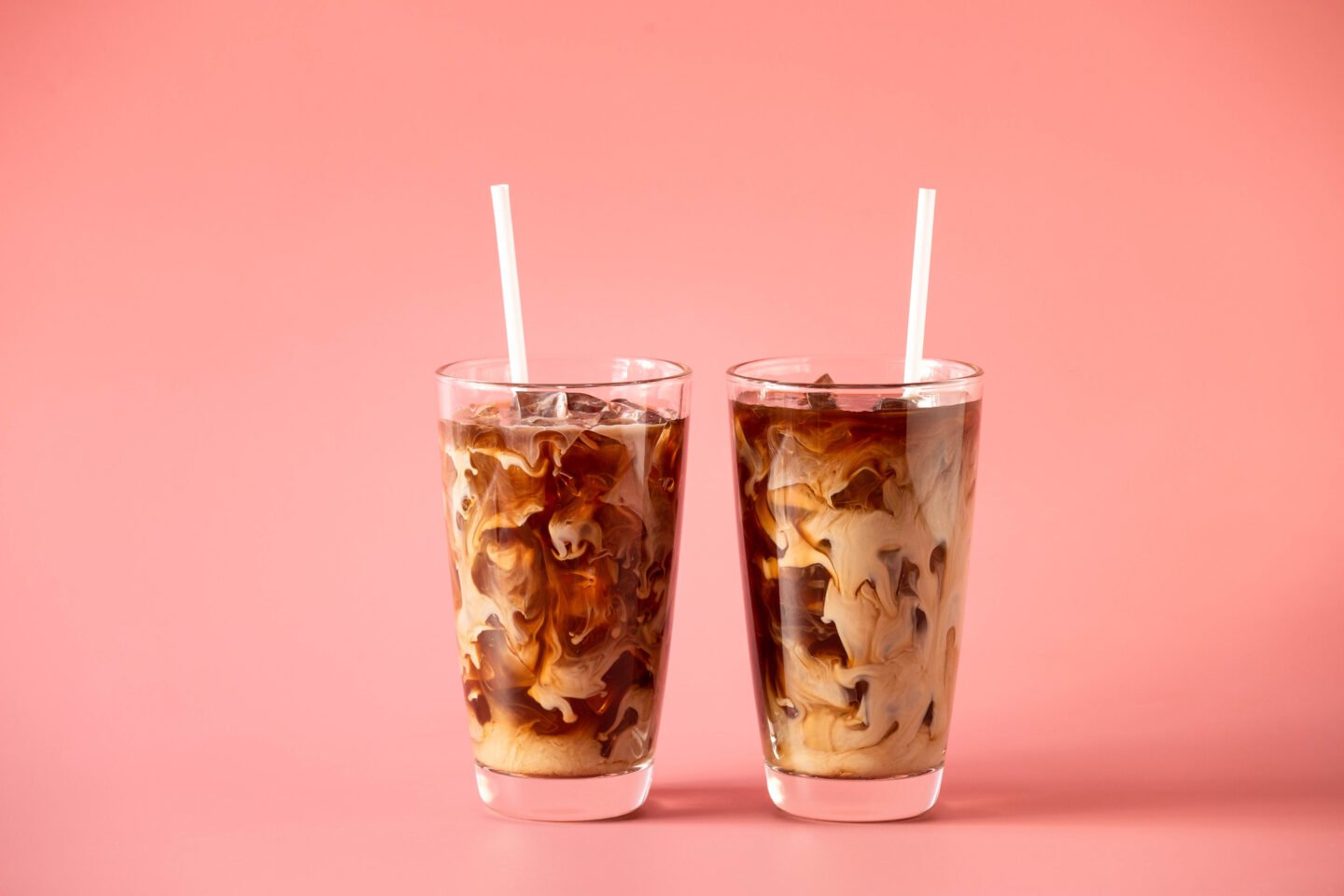 two-glasses of-coffee-milk-on-pink-background.