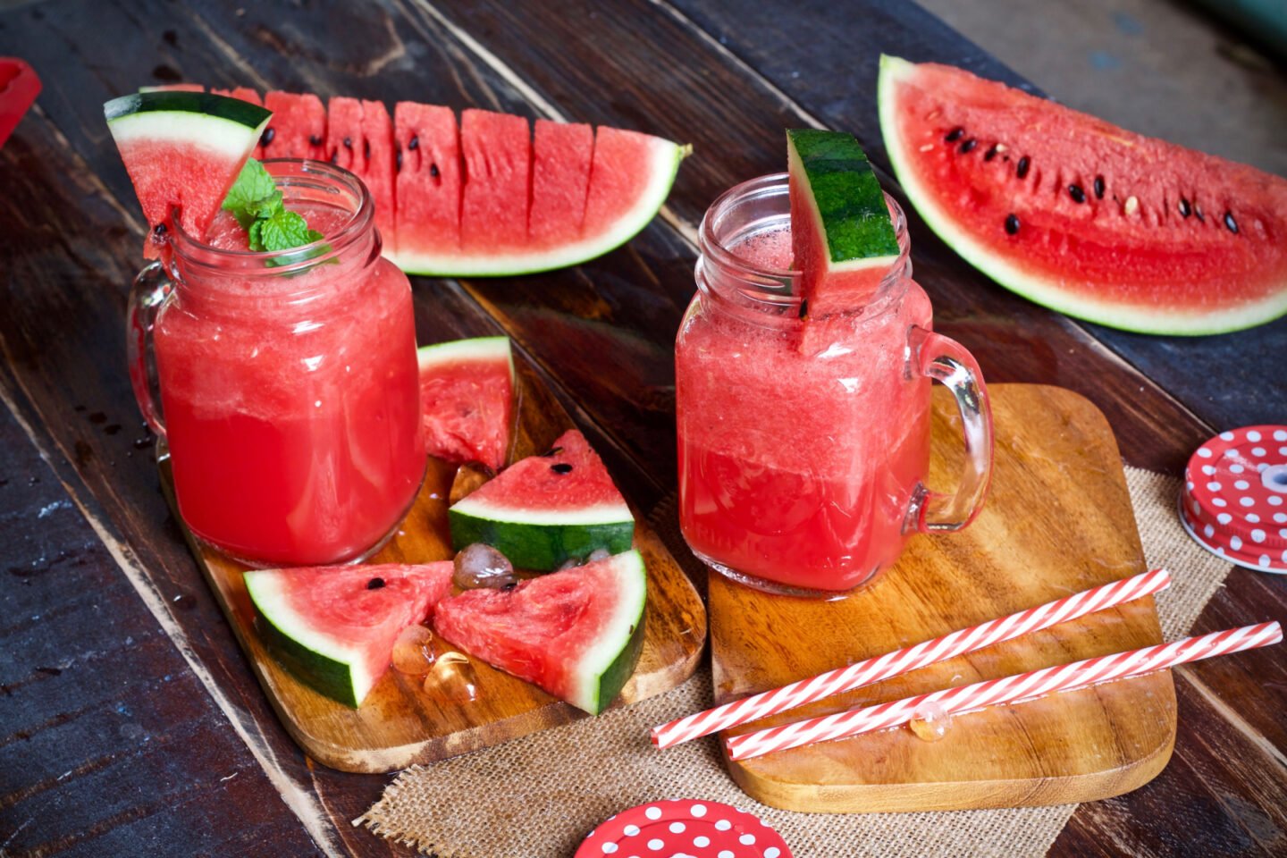 watermelon smoothie or juice in jars with fresh watermelon slices