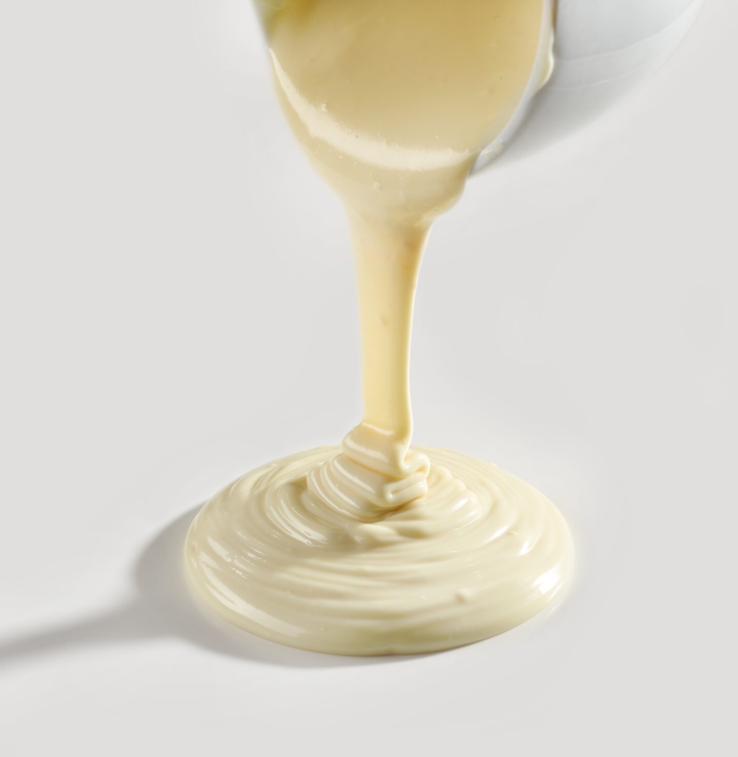 white-chocolate-sauce-being-poured-from-container