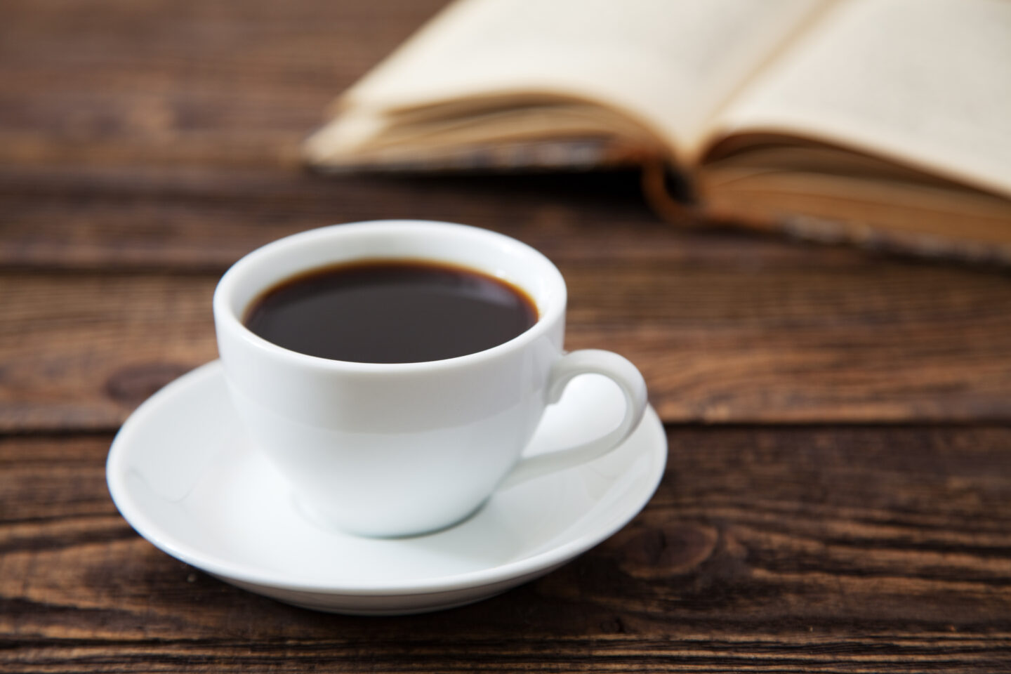 white-cup-of-coffee-on-a-wooden-table