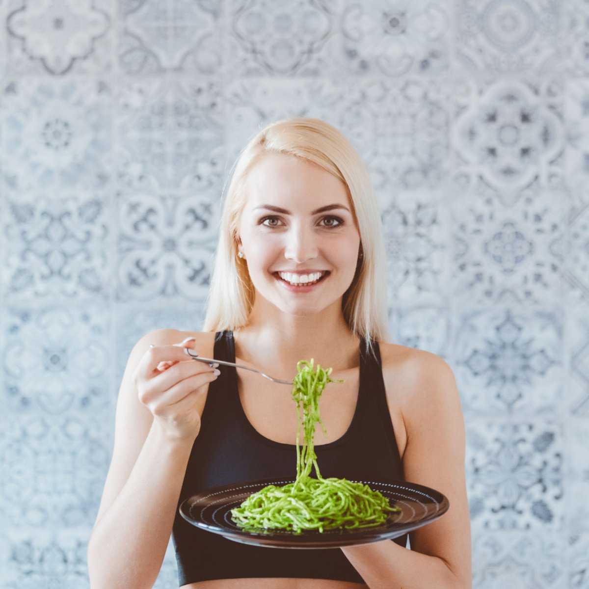 woman eating pesto pasta