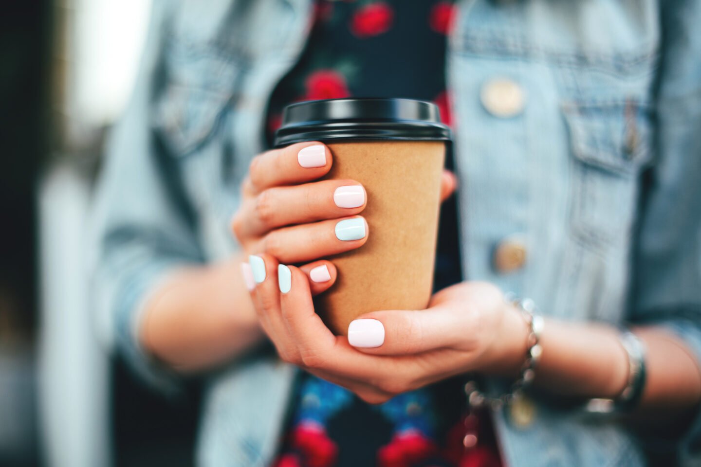 woman-holding-a-cup-of-hot-coffee-to-go