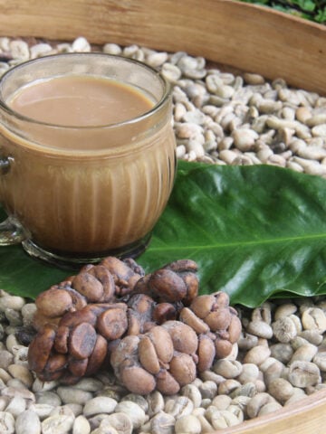 a-cup-of-coffee-beside-kopi-luwak-beans