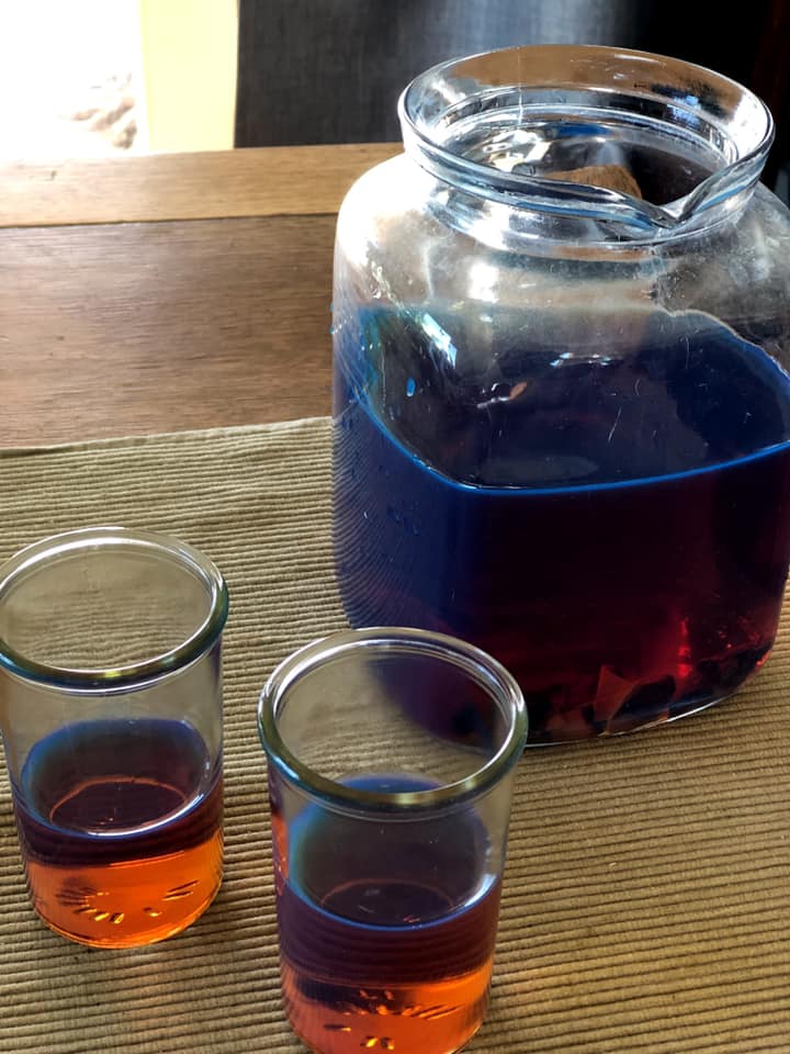 a jar of palo azul tea and two glasses