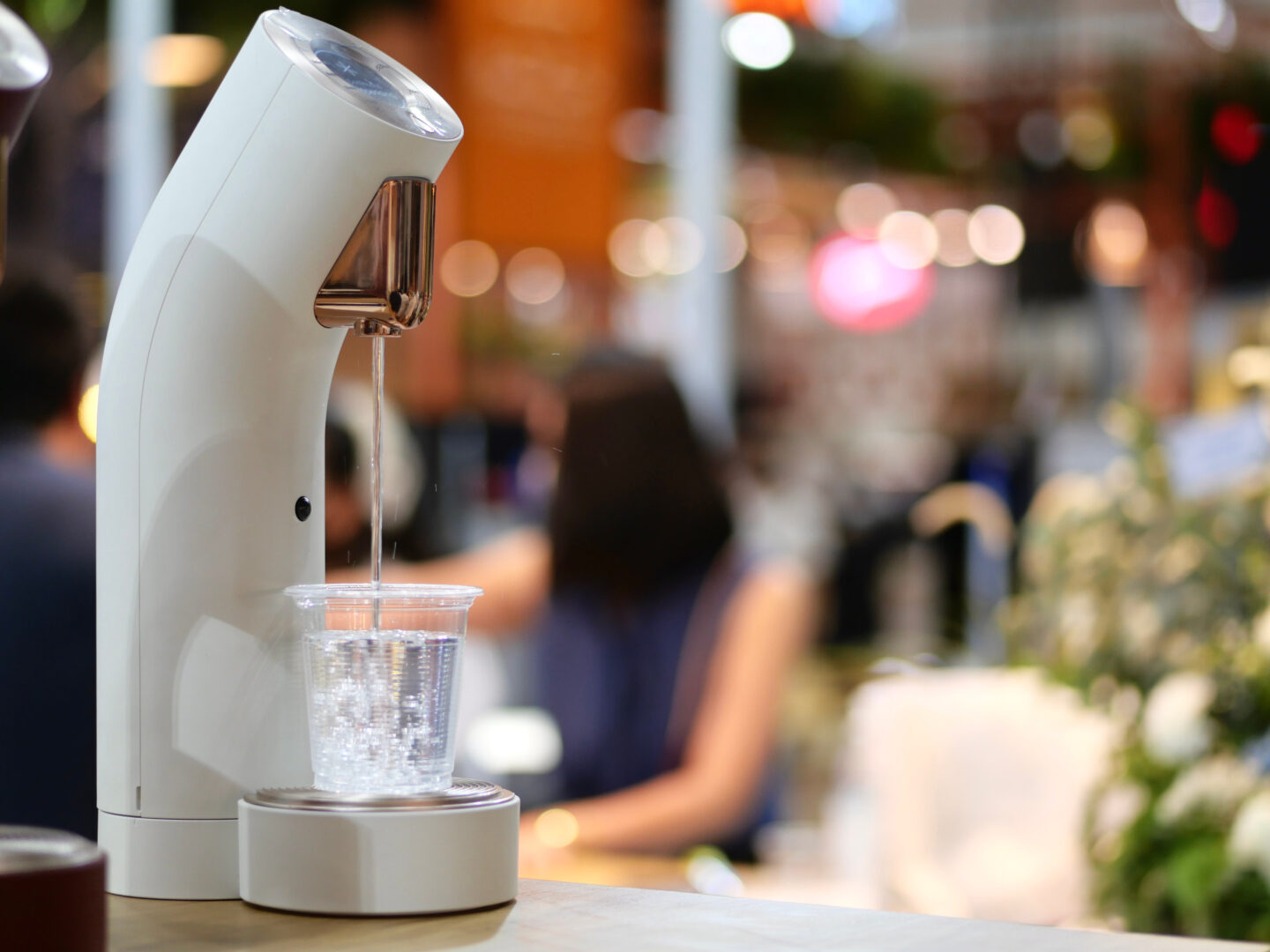 a-modern-white-faucet-is-pouring-water-into-a-plastic-glass